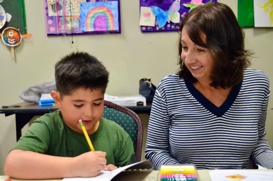 Cristianne working with a student